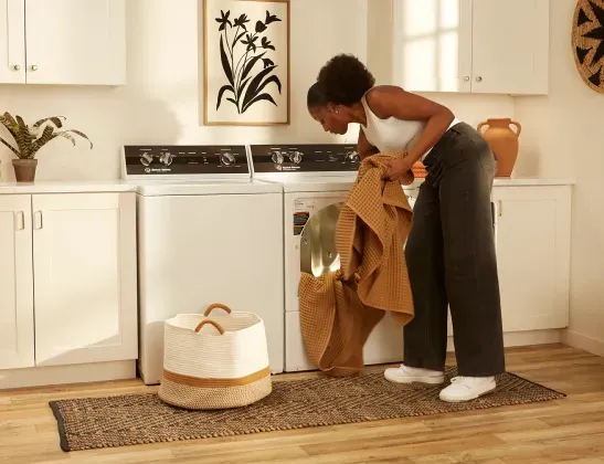 speed-queen-tr3-washer-woman-unloading-dryer